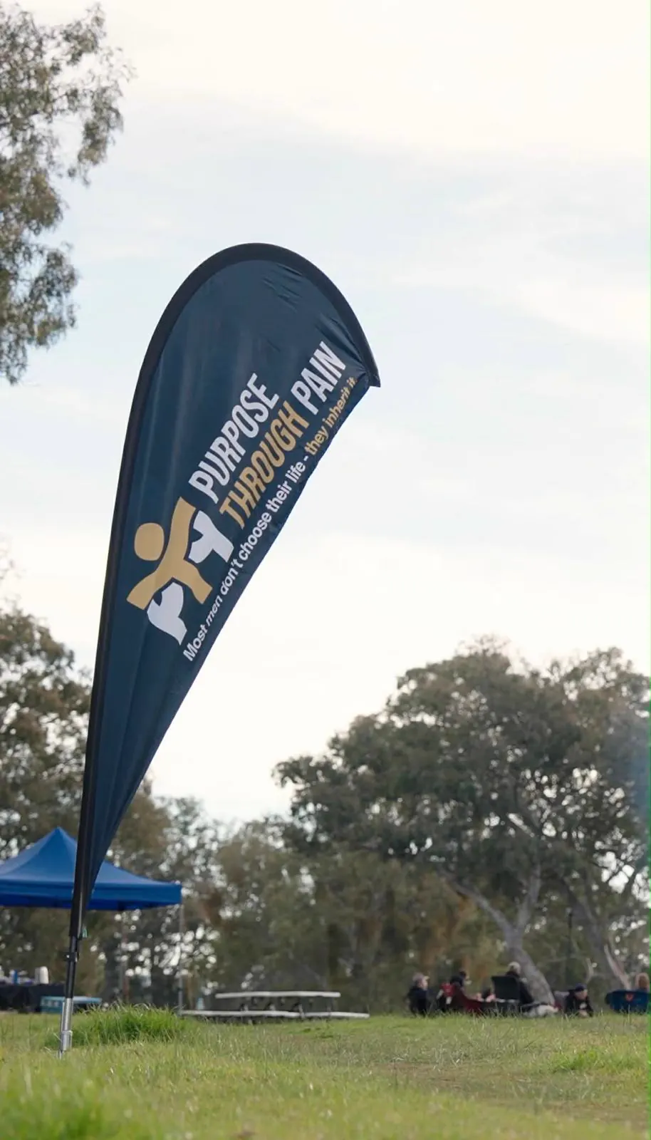 The Purpose Through Pain flag against a clear winter sky